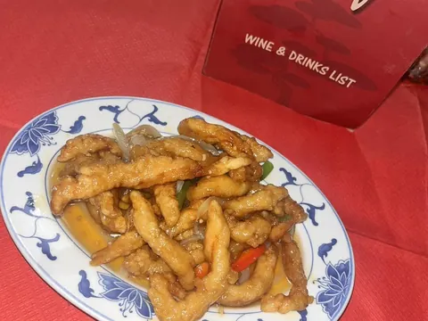 Salt and chilli chicken on a blue and white plate