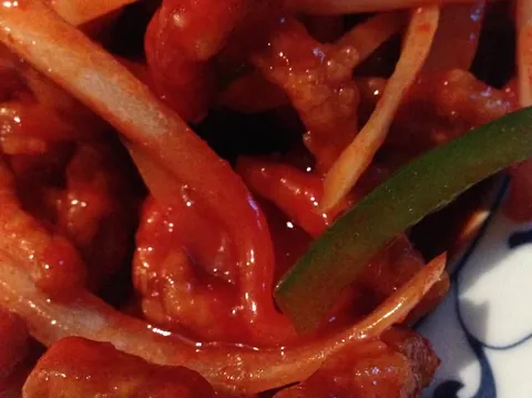 Sweet and sour chicken with peppers and onion